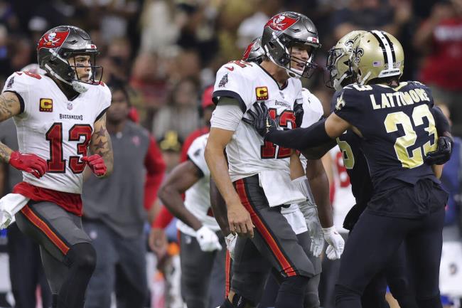 Tampa Bay Buccaneers wide receiver Mike Evans (13), quarterback Tom Brady (12) and New Orleans Saints cornerback Marshon Lattimore (23) get into an altercation during the second half of an NFL football game, Sunday, Sept. 18, 2021, in New Orleans. (AP Photo/Jo<em></em>nathan Bachman)