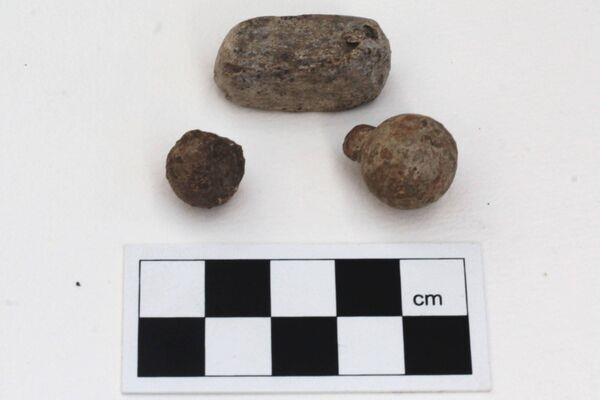 A musket and pistol ball with a small ingot of lead found during excavations at Carrignacurra Castle in Cork. 